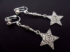 A pair of pretty hand made tibetan silver star dangly clip on earrings. new. Silver Clip-on Earrings For Jewelry Making, Silver Clip-on Dangle Jewelry, Silver Dangle Clip-on Jewelry, Silver Star Clip-on Earrings For Gift, Silver Dangle Clip-on Earrings With Ear Wire, Silver Drop Clip-on Earrings For Jewelry Making, Bohemian Sterling Silver Clip-on Earrings, Bohemian Sterling Silver Nickel-free Clip-on Earrings, Clip-on Dangle Plug Earrings As Gift