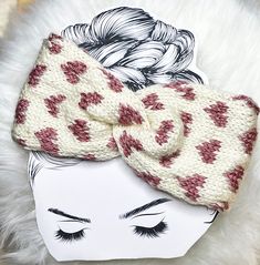 a white and red knitted headband with hearts on it