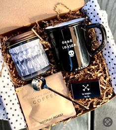 a gift box containing two coffee mugs, an old fashioned grinder and some other items