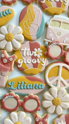 decorated cookies are arranged in the shape of flowers and peace signs