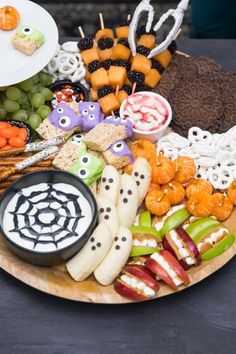 a platter filled with lots of different types of food on top of a table