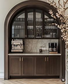 a kitchen with an arched cabinet and marble counter top