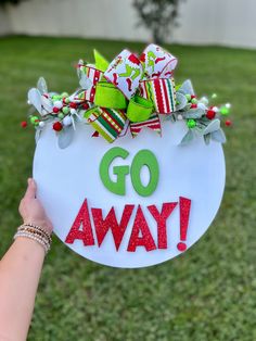 "Go Away Grinch Door Hanger  Dimensions for this sign are 16\"  All of our rounds and the letters are cut from 1/4\" birch wood, no vinyl is used. The backing of the sign is left unfinished. On the back of the round there is twine attached for hanging.   The door hangers are for indoor/outdoor use. We recommend not having the sign in direct sunlight as this could cause fading.Please note that we use real wood so each item will vary due to the nature of the wood (knots and the grain of the wood)* Bow and greenery can vary (will be the closest of what we have in stock to the picture).   Please message me with any questions or requests.  Thank you for visiting!!" Simple Grinch Wreath, Grinch Door Sign Diy, Grinch Entryway, Grinch Outside Decor, Grinch Office Door Decorating Ideas, Grinch Room Decor, Grinch Outdoor Decor, Grinch Door Decor, Funny Christmas Door Hangers