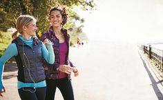 two women are walking down the street together