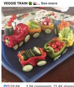 a blue plate topped with veggies shaped like cars