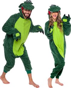 man and woman in green alligator onesuits posing for the camera with their hands up