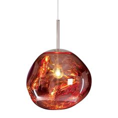 a red glass light hanging from a ceiling fixture with a white cord in front of it