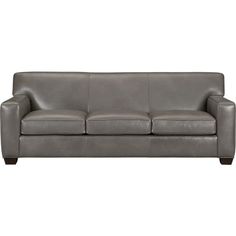 a gray leather couch sitting on top of a white floor