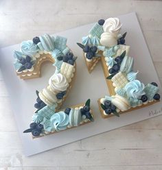 a cake shaped like the number twenty two with flowers and seashells on it