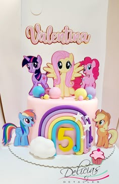 a birthday cake decorated with little pony and rainbows