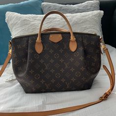 Authentic (Bags Are Sent To Poshmark First To Confirm Authenticity). This Classic Louis Vuitton Turenne Tote Is Rendered In The House's Iconic Monogram Canvas With Natural Vachetta Leather Trim And Is Finished With Gold-Tone Brass Hardware. * Features: * Adjustable And Removable Shoulder Strap And Two Top Handles * Top Zip Closure * Three Interior Slip Pockets * Coated Canvas * Fabric Lining * Gold Hardware * Details: * Length: 15.5" (39 Cm) * Height: 9.5" (24 Cm) * Depth: 6" (15 Cm) * Strap Drop: 4" (10 Cm) Very Good Condition. Wear On Base Corners And In Interior, Moderate Darkening And Creasing. Louis Vuitton Turenne, Authentic Bags, Brass Hardware, Monogram Canvas, Leather Trim, Leather Trims, Gold Hardware, Louis Vuitton Bag, Canvas Fabric