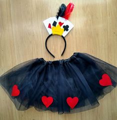 a black tutu skirt with red hearts on the bottom and a yellow headband