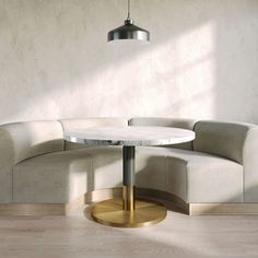 a white couch sitting next to a round table