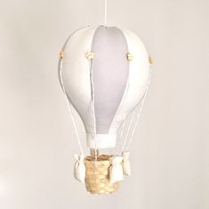 a white hot air balloon hanging from a string