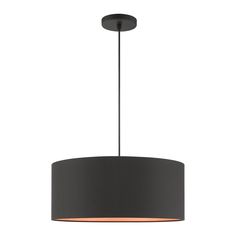 a black drum light hanging from the ceiling