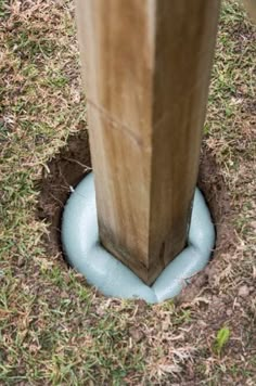 a hole in the ground with a wooden post