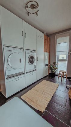 a washer and dryer sitting in a room next to each other on the floor