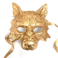 This unique golden masquerade mask set features a charming fox mask for your daughter and a fierce wolf mask for you. These masks symbolize the bond between a protective wolf and an adventurous fox. Let the magic of masquerade bring you closer and create treasured memories that will last a lifetime. Age Group/Gender - Adult/Kid Size/Type - One size fits all adults and children Mask Color - Gold Mask Material - Wolf: Polyresin. Fox: Laser cut metal Accent Material - Paint Animal Masquerade Mask, Werewolf Mask, Masquerade Mask Women, Fox Halloween, Couples Masquerade Masks, Werewolf Costume, Metal Mask, Wolf Mask, Haunted House Props