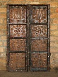 an old wooden door with decorative designs on it