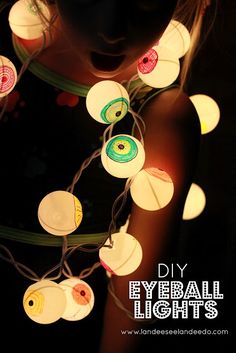 an image of some lights that are made out of paper and stringing with eyeballs on them