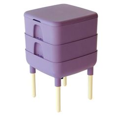 three purple plastic containers stacked on top of each other with wooden legs and one lid