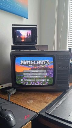 an old tv sitting on top of a wooden desk