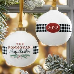 two ornaments hanging from a christmas tree with the words, the donnans merry christmas