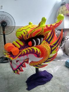 a brightly colored dragon head on a stand