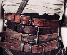 the belted man is wearing all his brown belts