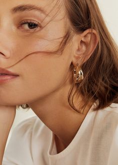 a close up of a person wearing some kind of earring on her left ear