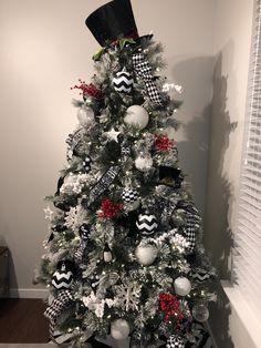 a decorated christmas tree with black and white ornaments