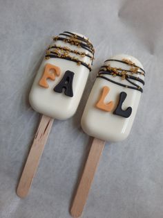 two marshmallows with chocolate and gold decorations on them