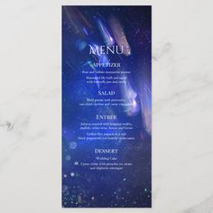 a menu card with an image of the space and stars in it on a marble surface