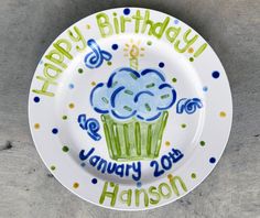 a happy birthday plate with a cupcake on it