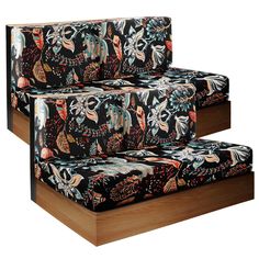 a set of three black and multicolored couches with floral designs on them