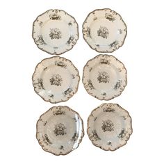 four plates with black and white designs on them