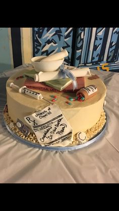 there is a cake with books on it and some writing on the frosted cake