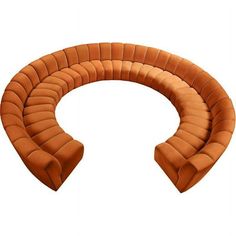 an orange curved couch sitting on top of a white floor