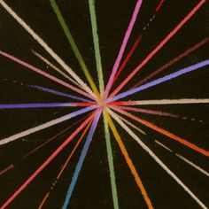 a black background with multicolored lines in the shape of a sunburst