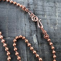 One (1) pure copper necklace ballchain with artisan clasp and wire wrapped loops. All necklace parts are solid copper. Chain is 4.5mm wide. Choose handmade clasp from 2 styles: ► swirl hook & loop ► simple hook & loop The clasp hooks through the wrapped loop on the end of the chain. Clasp is handmade to order from reclaimed solid copper wire and may vary slightly in shape and size from that shown in the photos. The end loop of the chain is about 6.5mm across. If you will be adding a pend Wired Jewelry, Wire Clasp, Copper Chain Necklace, Ball Chain Necklace, Copper Necklace, Copper Chain, Copper Pendants, Brass Chain, Stainless Steel Necklace