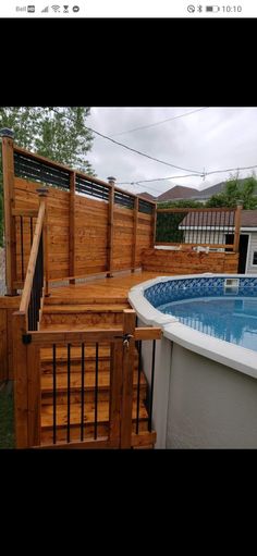 an above ground pool surrounded by wooden decks