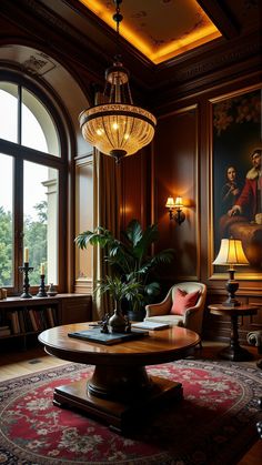 a living room filled with furniture and a large painting on the wall above it's windows