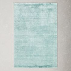 a light blue rug on a white wall