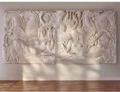 a large white wall sculpture in an empty room