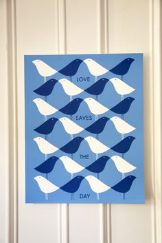 a blue and white poster with birds saying love saves the day on it's side