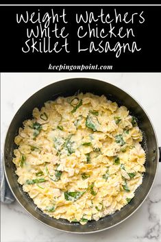 a skillet filled with macaroni and cheese on top of a marble counter