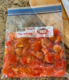 a bag of tomatoes sitting on top of a counter