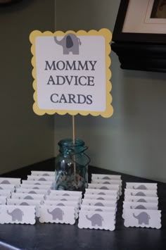 there is a sign that says mommy advice cards next to some small boxes with elephants on them