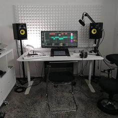 a computer desk with speakers on top of it