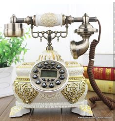 an old fashioned phone sitting on top of a wooden table